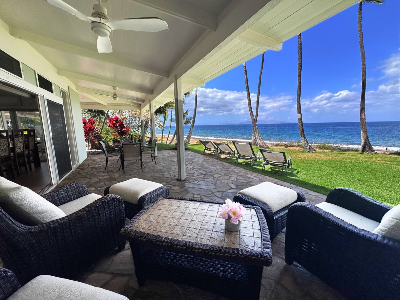 Oceanfront patio with lounge seating and direct beach access